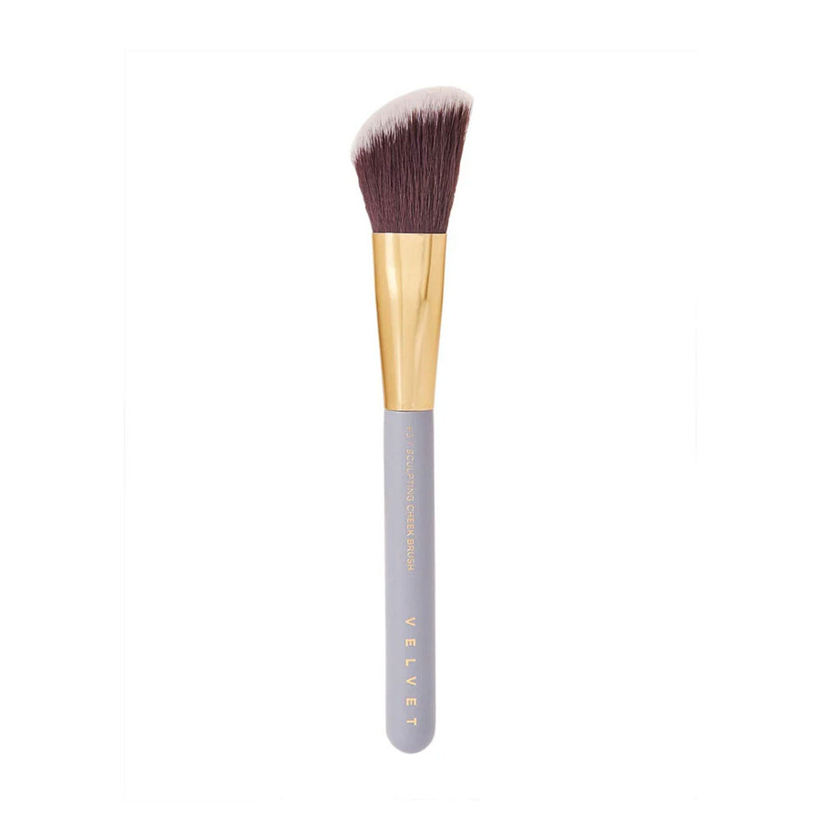 Makeup brush with gold ferrule and gray handle on a white background