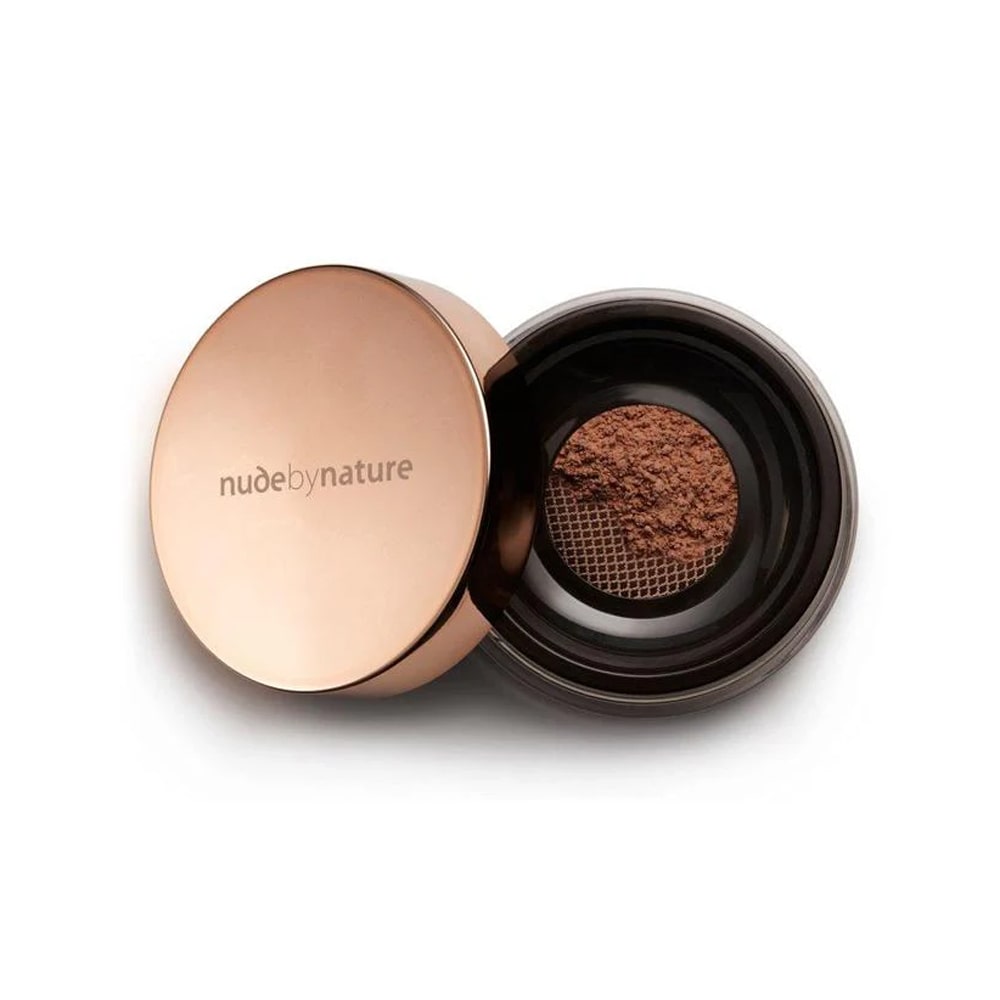 Open rose gold container of powder with 'nude by nature' branding on a white background